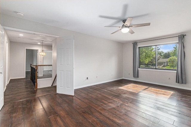 2315 Adare Rd, Ann Arbor, MI 48104 - empty room with dark wood-style flooring, ceiling fan, baseboards, and a chandelier