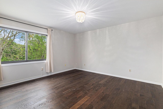 2315 Adare Rd, Ann Arbor, MI 48104 - spare room with a chandelier, dark wood-style flooring, and baseboards