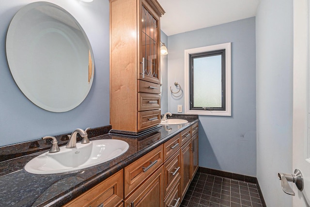 2315 Adare Rd, Ann Arbor, MI 48104 - bathroom with double vanity, tile patterned floors, and baseboards
