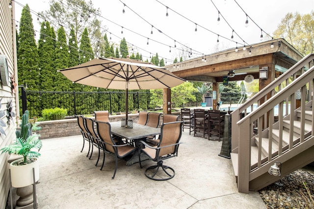 5221 Whittaker Trl, Linden, MI 48451 - view of patio with outdoor dining area, fence, and stairway