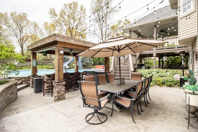 5221 Whittaker Trl, Linden, MI 48451 - view of patio / terrace featuring stairway, fence, and outdoor dining space