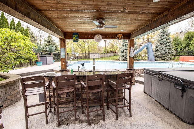 5221 Whittaker Trl, Linden, MI 48451 - view of patio / terrace with fence, a hot tub, and a bar