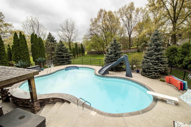 5221 Whittaker Trl, Linden, MI 48451 - view of swimming pool featuring a water slide, a fenced backyard, a diving board, and a patio area