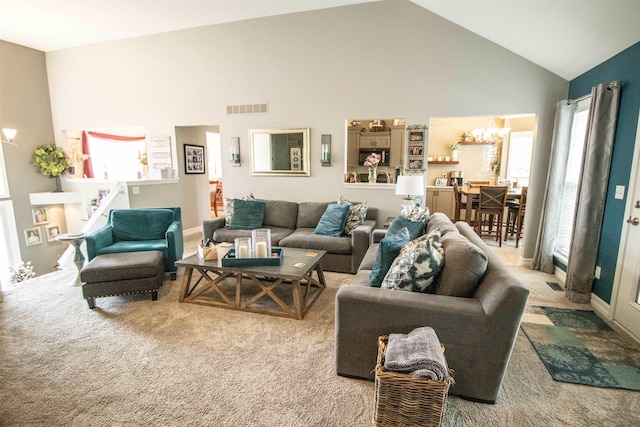 5221 Whittaker Trl, Linden, MI 48451 - carpeted living area featuring a chandelier and high vaulted ceiling