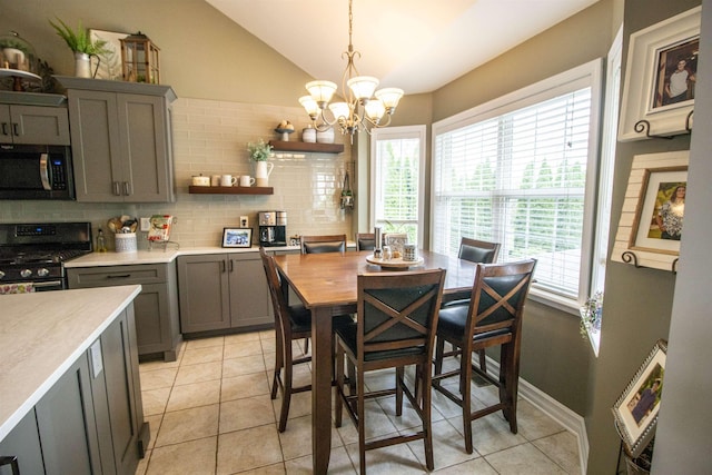5221 Whittaker Trl, Linden, MI 48451 - dining room featuring a chandelier, vaulted ceiling, and light tile patterned floors