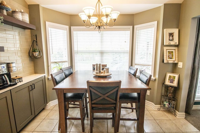 5221 Whittaker Trl, Linden, MI 48451 - dining space featuring light tile patterned flooring, plenty of natural light, a chandelier, and baseboards