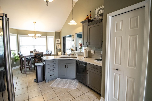 5221 Whittaker Trl, Linden, MI 48451 - kitchen with gray cabinetry, dishwashing machine, a sink, a chandelier, and light tile patterned flooring
