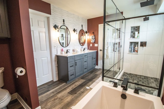 5221 Whittaker Trl, Linden, MI 48451 - bathroom with toilet, a shower stall, wood finished floors, double vanity, and a tub