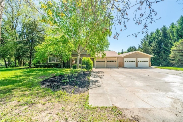 7045 Crane Rd, Ypsilanti, MI 48197 - view of front of home with a front lawn, concrete driveway, and a detached garage