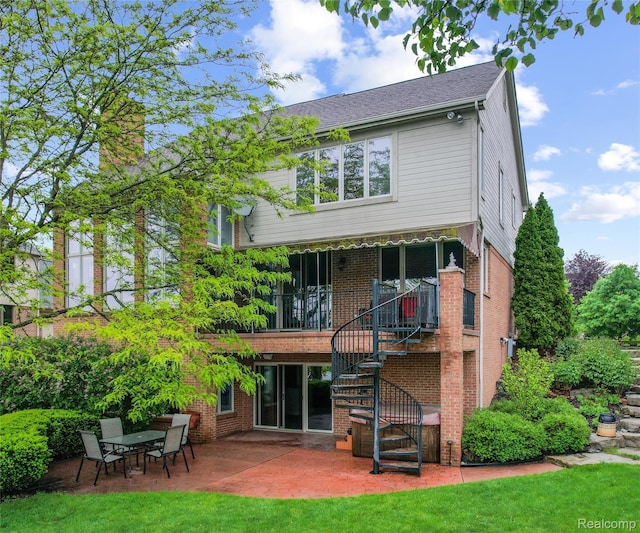 17747 Parkshore Dr, Northville, MI 48168 - rear view of house with a patio, stairway, a chimney, a yard, and brick siding