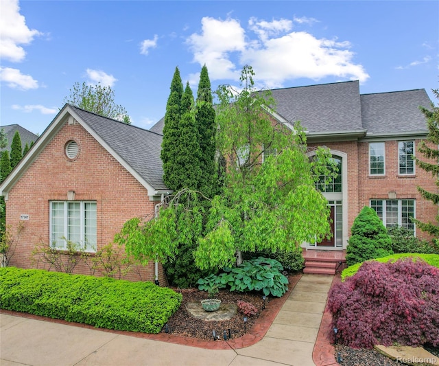 17747 Parkshore Dr, Northville, MI 48168 - view of front facade with a shingled roof and brick siding