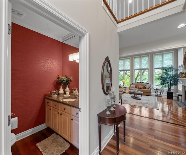 17747 Parkshore Dr, Northville, MI 48168 - hallway featuring dark wood-style flooring, a sink, and baseboards