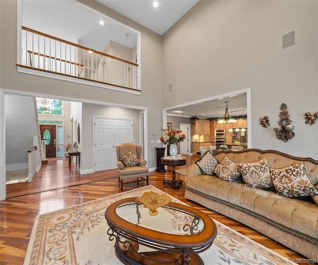 17747 Parkshore Dr, Northville, MI 48168 - living area with a towering ceiling, wood finished floors, baseboards, and recessed lighting