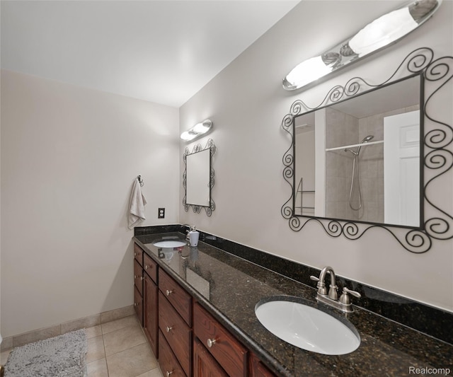 17747 Parkshore Dr, Northville, MI 48168 - bathroom featuring double vanity, tiled shower, tile patterned floors, and baseboards