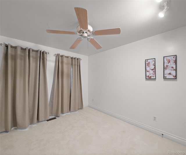 17747 Parkshore Dr, Northville, MI 48168 - empty room featuring light colored carpet, a ceiling fan, and baseboards