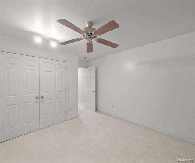 17747 Parkshore Dr, Northville, MI 48168 - unfurnished bedroom with light colored carpet, a closet, baseboards, and ceiling fan