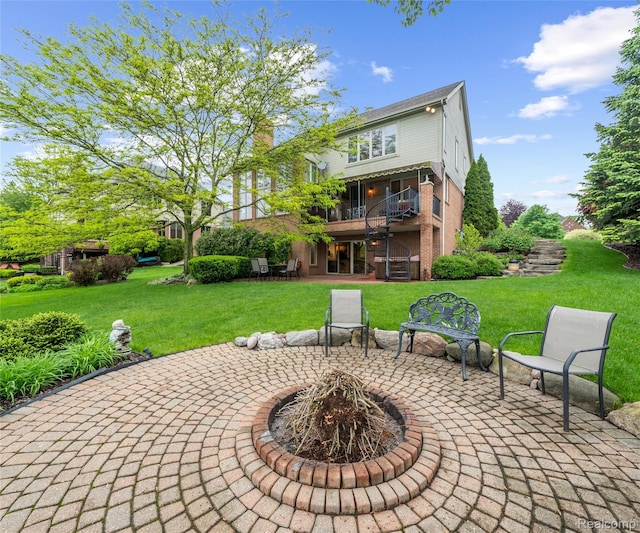 17747 Parkshore Dr, Northville, MI 48168 - rear view of property featuring a patio, brick siding, a lawn, and an outdoor fire pit