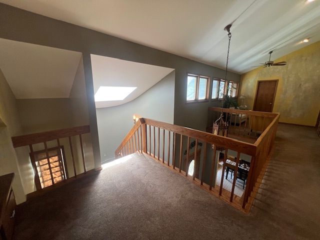 6600 Park Valley Dr, Clarkston, MI 48348 - corridor with vaulted ceiling, carpet floors, an upstairs landing, and a skylight