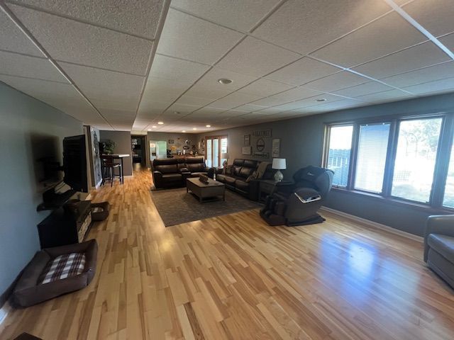 6600 Park Valley Dr, Clarkston, MI 48348 - living area with a drop ceiling, wood finished floors, and baseboards