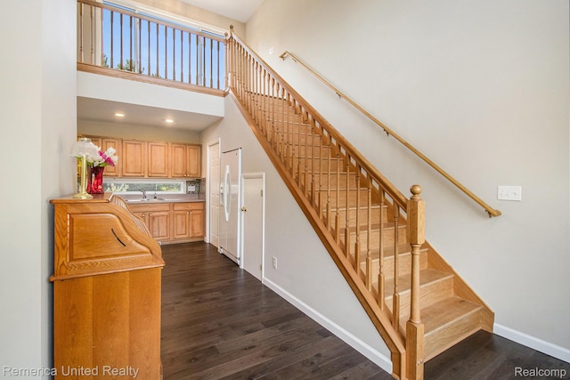400 E Schafer Rd, Pinckney, MI 48169 - stairs featuring wood finished floors and a towering ceiling