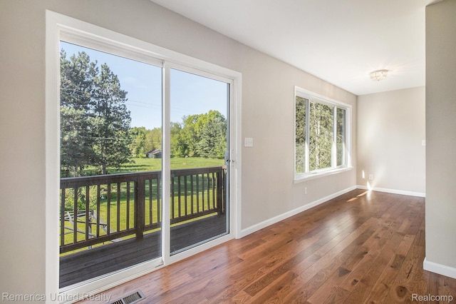 400 E Schafer Rd, Pinckney, MI 48169 - doorway to outside with baseboards and wood-type flooring
