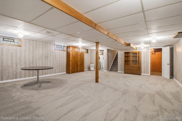 400 E Schafer Rd, Pinckney, MI 48169 - below grade area with carpet floors, stairway, a paneled ceiling, plenty of natural light, and wood walls