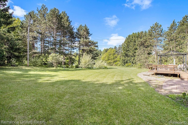 400 E Schafer Rd, Pinckney, MI 48169 - view of grassy yard featuring a gazebo, a wooden deck, and view of scattered trees