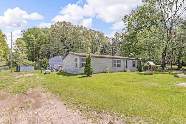 3749 Wellman Rd, Parma, MI 49269 - rear view of property with a lawn, dirt driveway, an outbuilding, and entry steps