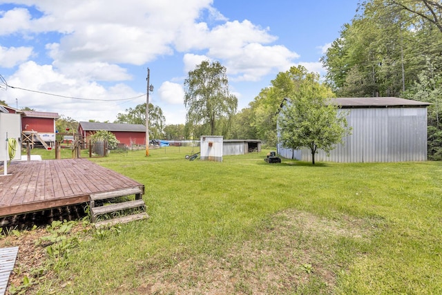 3749 Wellman Rd, Parma, MI 49269 - view of grassy yard featuring an outbuilding, a deck, and a pole building