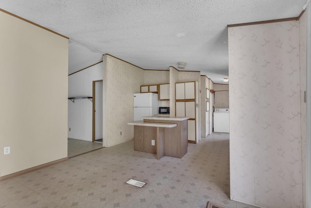 3749 Wellman Rd, Parma, MI 49269 - kitchen featuring freestanding refrigerator, light flooring, a center island, washer / dryer, and a textured ceiling