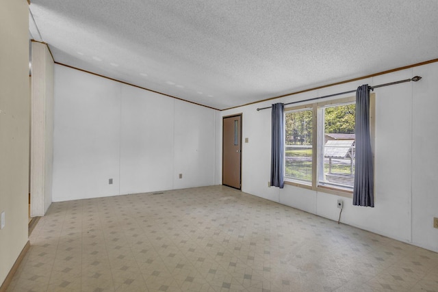 3749 Wellman Rd, Parma, MI 49269 - unfurnished room with tile patterned floors and a textured ceiling