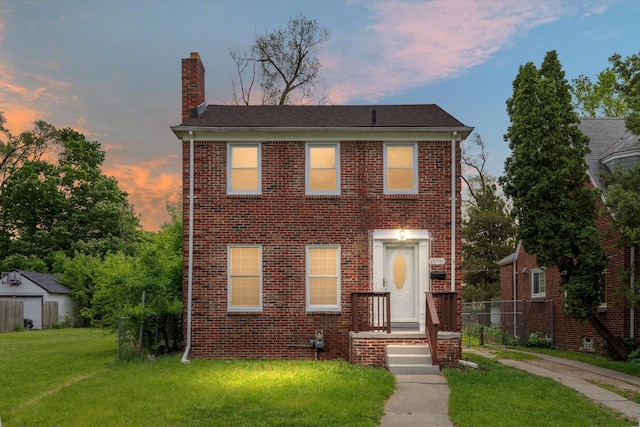 15770 Mansfield St, Detroit, MI 48227 - view of front facade featuring a chimney, a front lawn, and brick siding