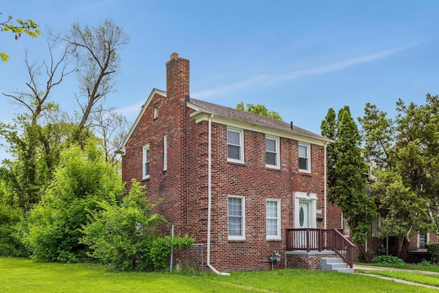15770 Mansfield St, Detroit, MI 48227 - view of property exterior featuring a chimney, a yard, and brick siding