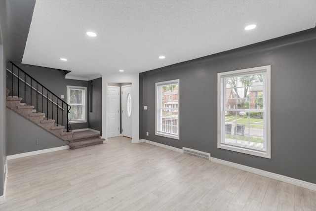15770 Mansfield St, Detroit, MI 48227 - foyer featuring a textured ceiling, recessed lighting, wood finished floors, baseboards, and stairs