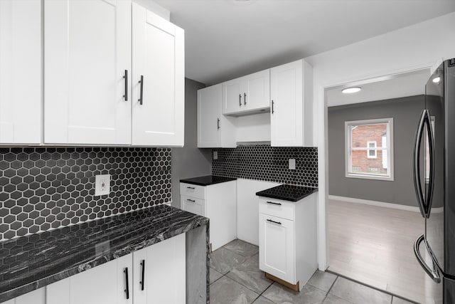 15770 Mansfield St, Detroit, MI 48227 - kitchen with freestanding refrigerator, white cabinetry, tasteful backsplash, and dark stone counters
