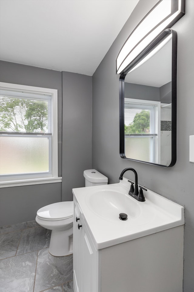 15770 Mansfield St, Detroit, MI 48227 - bathroom featuring healthy amount of natural light, vanity, marble finish floors, and toilet