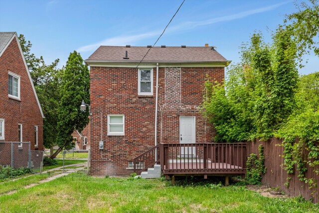 15770 Mansfield St, Detroit, MI 48227 - rear view of house featuring fence, a deck, and brick siding