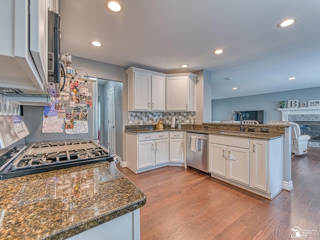469 Corinth Cir, Dundee, MI 48131 - kitchen with stainless steel dishwasher, light wood-style floors, a peninsula, white cabinetry, and a sink