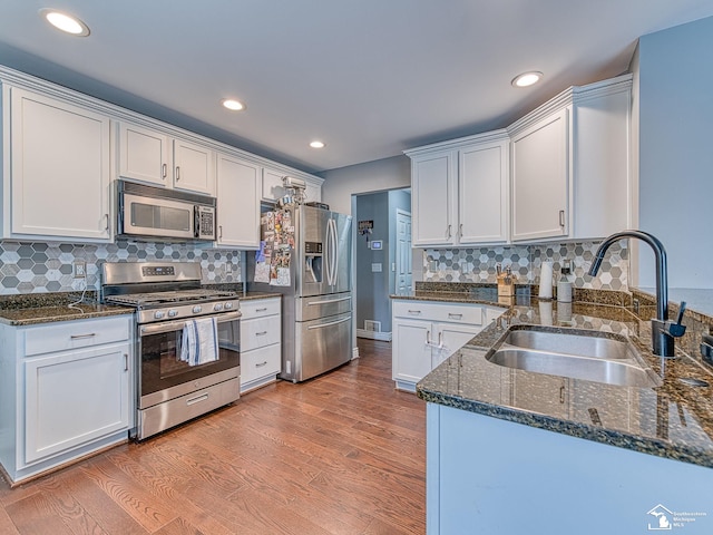 469 Corinth Cir, Dundee, MI 48131 - kitchen with stainless steel appliances, a sink, white cabinetry, and recessed lighting