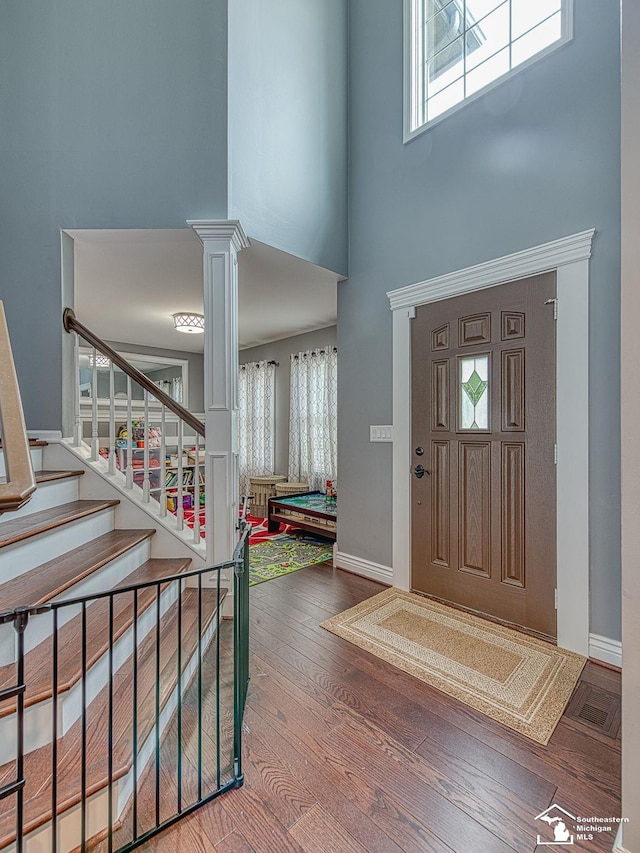 469 Corinth Cir, Dundee, MI 48131 - entrance foyer with a high ceiling, wood finished floors, decorative columns, stairway, and baseboards