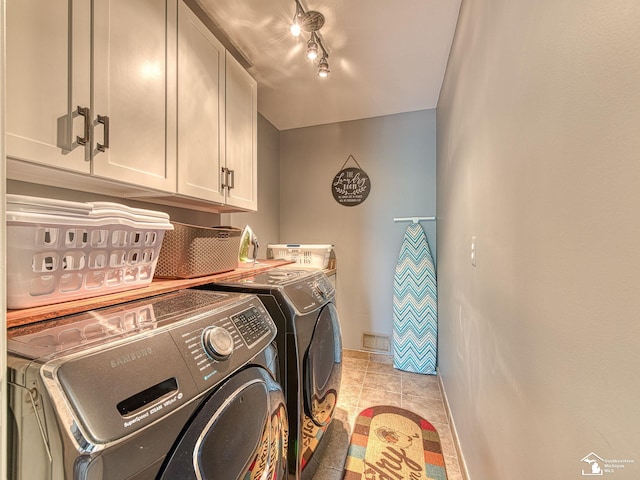 469 Corinth Cir, Dundee, MI 48131 - laundry room featuring washer and dryer, cabinet space, light tile patterned floors, and baseboards