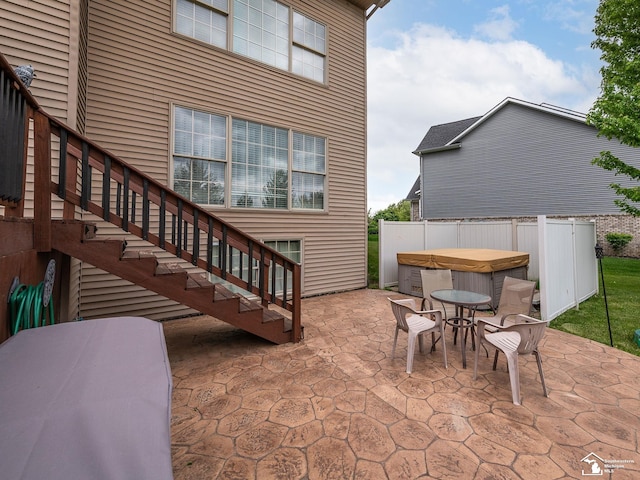 469 Corinth Cir, Dundee, MI 48131 - view of patio with a hot tub, outdoor dining space, stairs, and fence