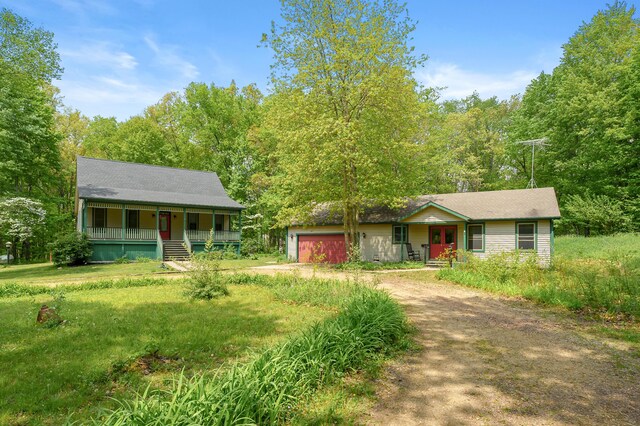 9934 W Fg Ave, Kalamazoo, MI 49009 - view of front facade featuring covered porch, driveway, french doors, and a garage