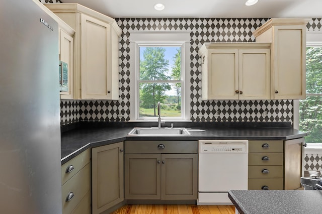 9934 W Fg Ave, Kalamazoo, MI 49009 - kitchen with stainless steel appliances, a sink, cream cabinetry, plenty of natural light, and wallpapered walls