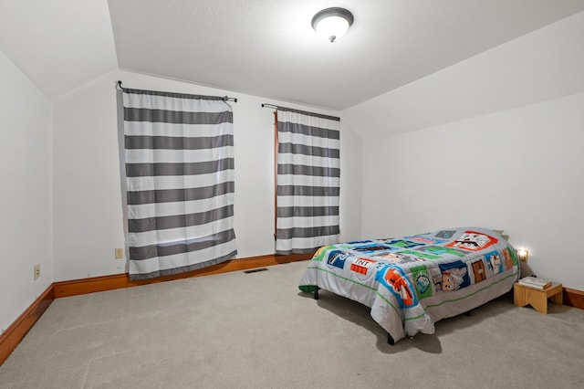 9934 W Fg Ave, Kalamazoo, MI 49009 - carpeted bedroom with vaulted ceiling and baseboards