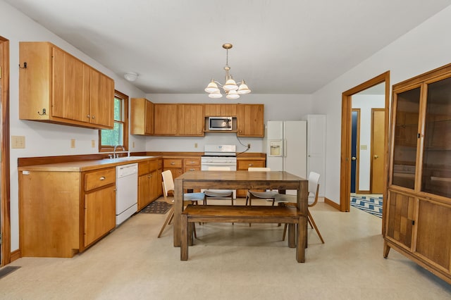 9934 W Fg Ave, Kalamazoo, MI 49009 - kitchen with white appliances, a chandelier, a sink, pendant lighting, and brown cabinets