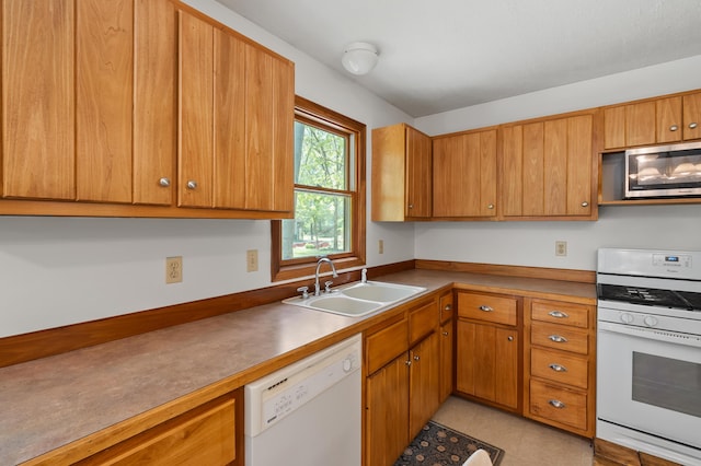 9934 W Fg Ave, Kalamazoo, MI 49009 - kitchen with white appliances, a sink, and brown cabinetry