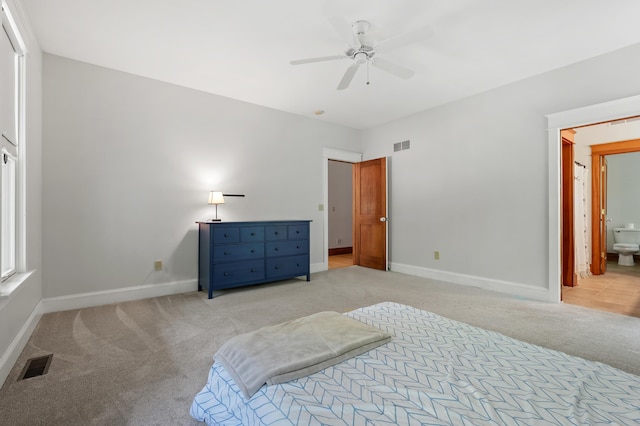 9934 W Fg Ave, Kalamazoo, MI 49009 - bedroom with light carpet, baseboards, ensuite bath, and a ceiling fan