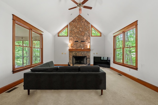 9934 W Fg Ave, Kalamazoo, MI 49009 - carpeted living area featuring ceiling fan, vaulted ceiling, a stone fireplace, and baseboards