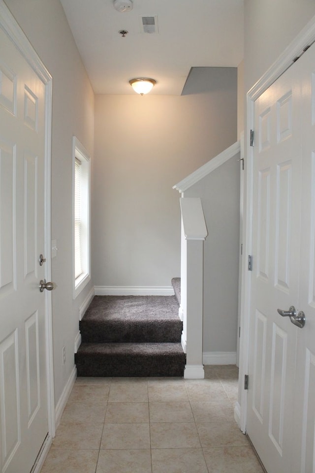45862 S Stonewood Rd Unit 218, Canton, MI 48187 - staircase with baseboards, carpet floors, and tile patterned floors